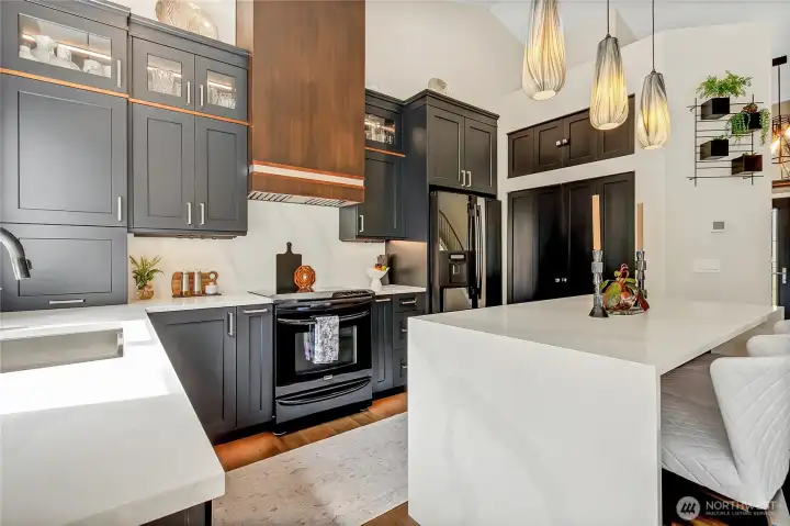Undermount 16-guage stainless steel sink w/accessories, a Delta Faucet, Insta-Hot dispenser and a custom walnut range hood with a 390 CFM system & remote control. Undermount 16-guage stainless steel sink w/accessories, a Delta Faucet, Insta-Hot dispenser and a custom walnut range hood with a 390 CFM system & remote control.