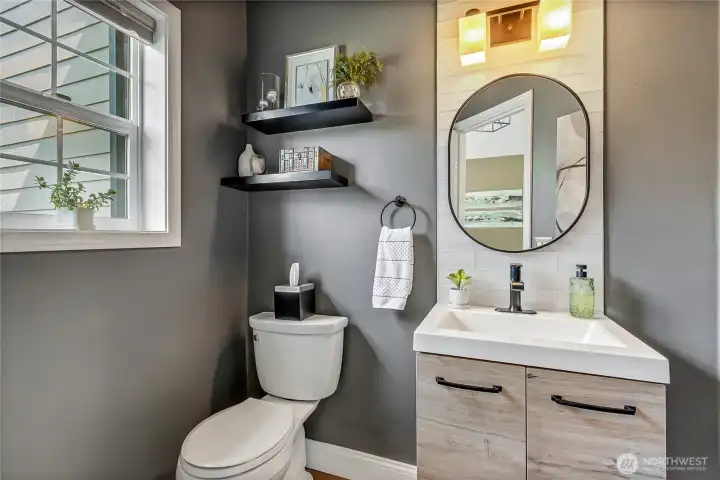 Floating Vanity with accent lighting, custom tile work, new mirror & light fixture, newer comfort-height toilet, wood-wrapped window and hard maple flooring. Floating Vanity with accent lighting, custom tile work, new mirror & light fixture, newer comfort-height toilet, wood-wrapped window and hard maple flooring.
