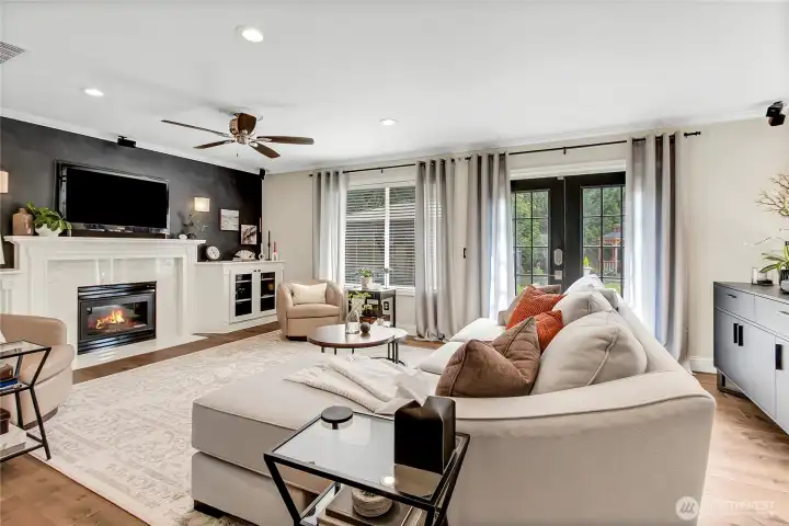 The oversized family room offers an inviting space for everyday living and entertaining, with elegant double glass doors opening to a beautifully landscaped, private backyard retreat that blends indoor comfort and outdoor enjoyment. The oversized family room offers an inviting space for everyday living and entertaining, with elegant double glass doors opening to a beautifully landscaped, private backyard retreat that blends indoor comfort and outdoor enjoyment.