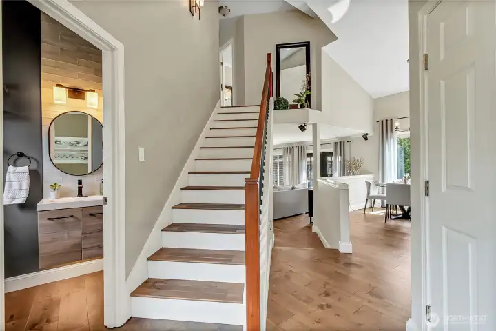 Elegant staircase leads to the private upper level, where the spacious primary suite and additional bedrooms are thoughtfully situated. Elegant staircase leads to the private upper level, where the spacious primary suite and additional bedrooms are thoughtfully situated.