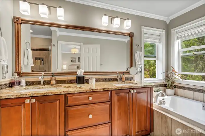 Primary bath is a beautifully appointed 5-piece retreat w/solid maple doors, 3 cm granite vanity top, double undermount porcelain sinks and Delta faucets. Primary bath is a beautifully appointed 5-piece retreat w/solid maple doors, 3 cm granite vanity top, double undermount porcelain sinks and Delta faucets.