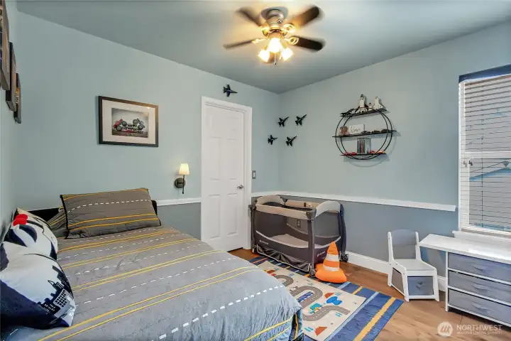 A spacious secondary bedroom features a walk-in closet with custom organization systems, maximizing storage and everyday functionality. A spacious secondary bedroom features a walk-in closet with custom organization systems, maximizing storage and everyday functionality.