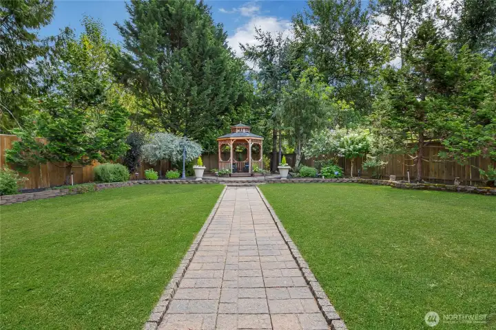 A charming paver pathway leads through the beautifully landscaped backyard to a gazebo, complete with lighting & tucked at the rear of the fully fenced, private yard and provides the perfect setting for evening relaxation or outdoor gatherings. A charming paver pathway leads through the beautifully landscaped backyard to a gazebo, complete with lighting & tucked at the rear of the fully fenced, private yard and provides the perfect setting for evening relaxation or outdoor gatherings.