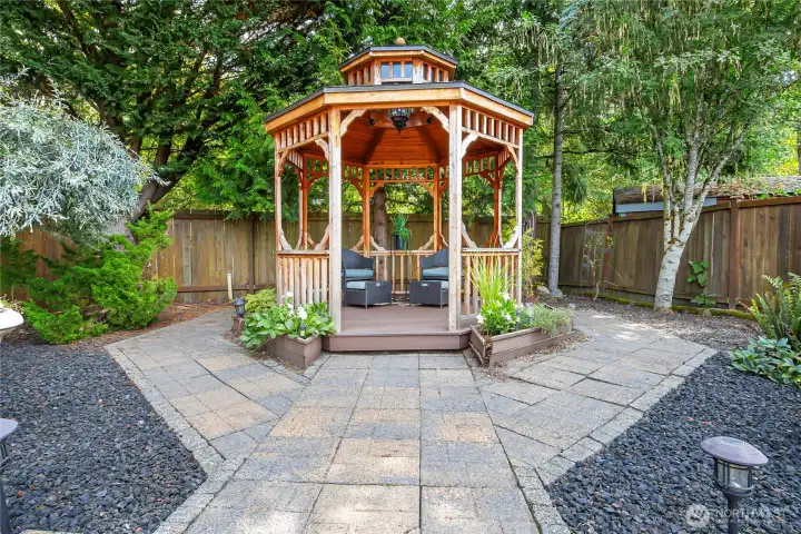 The private backyard retreat extends to a beautifully illuminated gazebo that is thoughtfully positioned for comfort and relaxation. The private backyard retreat extends to a beautifully illuminated gazebo that is thoughtfully positioned for comfort and relaxation.