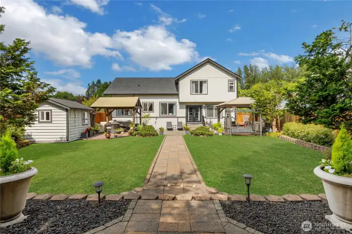 A true outdoor oasis, the fully fenced backyard offers an impressive collection of amenities including covered gathering spaces, an outdoor kitchen, Trex-deck, expansive patio areas, a charming lighted gazebo, and a powered shed. all surrounded by lush mature landscaping. A true outdoor oasis, the fully fenced backyard offers an impressive collection of amenities including covered gathering spaces, an outdoor kitchen, Trex-deck, expansive patio areas, a charming lighted gazebo, and a powered shed. all surrounded by lush mature landscaping.