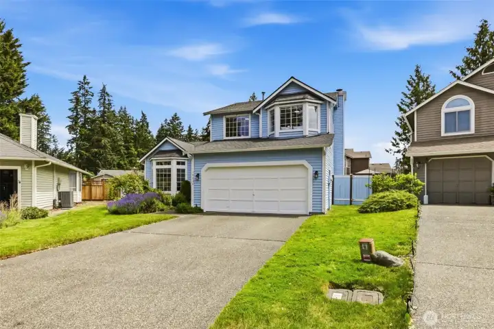 Additional front exterior perspective highlighting the home's two story design, well maintained grounds, and convenient parking. Additional front exterior perspective highlighting the home's two story design, well maintained grounds, and convenient parking.