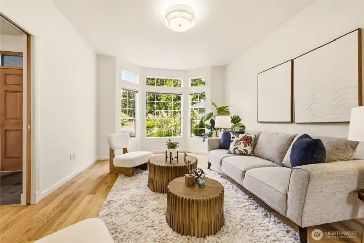 Bright living room with hardwood floors and abundant natural light, offering comfortable space for everyday living and entertaining. Bright living room with hardwood floors and abundant natural light, offering comfortable space for everyday living and entertaining.
