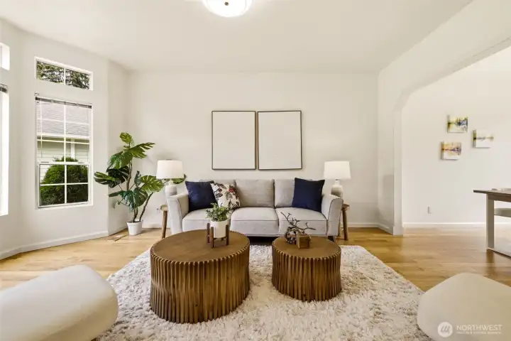 Inviting main living area featuring hardwood flooring, large windows, and an open feel that connects seamlessly with the rest of the home. Inviting main living area featuring hardwood flooring, large windows, and an open feel that connects seamlessly with the rest of the home.
