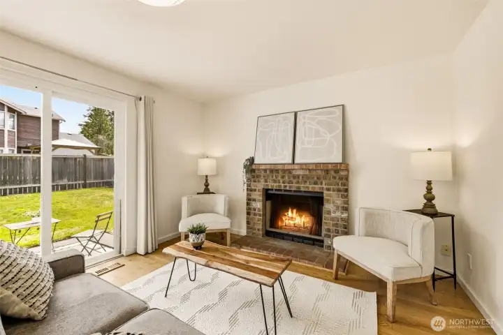 Comfortable family room with fireplace and backyard views, providing a cozy space to relax throughout the seasons. Comfortable family room with fireplace and backyard views, providing a cozy space to relax throughout the seasons.