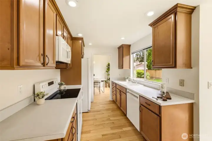 Kitchen view showcasing updated finishes, plentiful cabinet storage, and natural light overlooking the backyard. Kitchen view showcasing updated finishes, plentiful cabinet storage, and natural light overlooking the backyard.