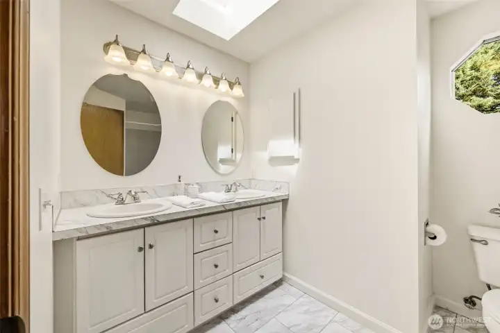 Primary bathroom featuring dual vanities, ample counter space, and practical storage for everyday routines. Primary bathroom featuring dual vanities, ample counter space, and practical storage for everyday routines.