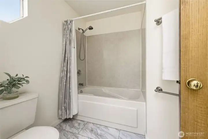 Full bathroom with tub and shower combination designed for convenience and versatility. Full bathroom with tub and shower combination designed for convenience and versatility.