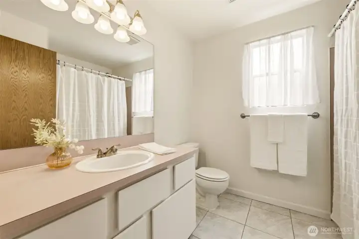 Additional full bathroom providing convenience for bedrooms and guests. Additional full bathroom providing convenience for bedrooms and guests.
