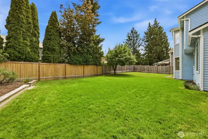 Additional backyard perspective showcasing lawn space, privacy fencing, and opportunities for outdoor enjoyment. Additional backyard perspective showcasing lawn space, privacy fencing, and opportunities for outdoor enjoyment.