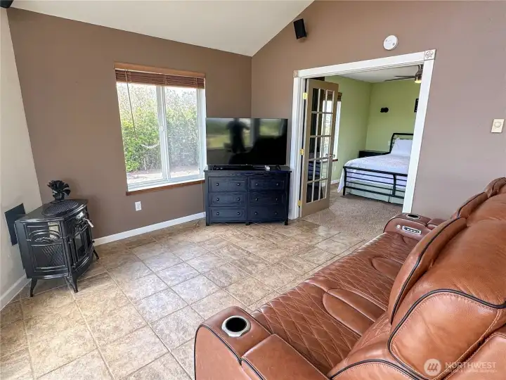 Lovely living room space to entertain, or unwind! French doors lead to the first bedroom.