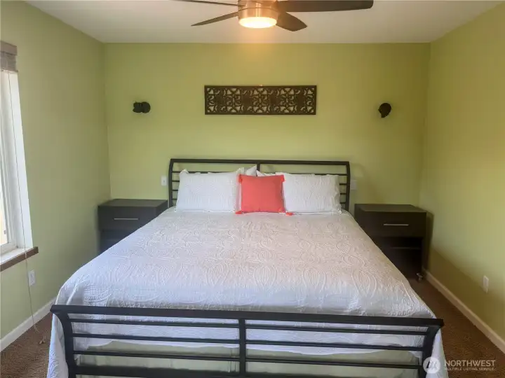 Well sized bedroom with ceiling fan for added comfort.