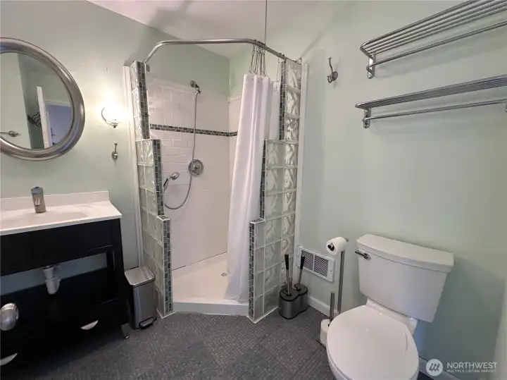 Down the hall you will find the spacious shower with a fantastic tiled step-in shower!