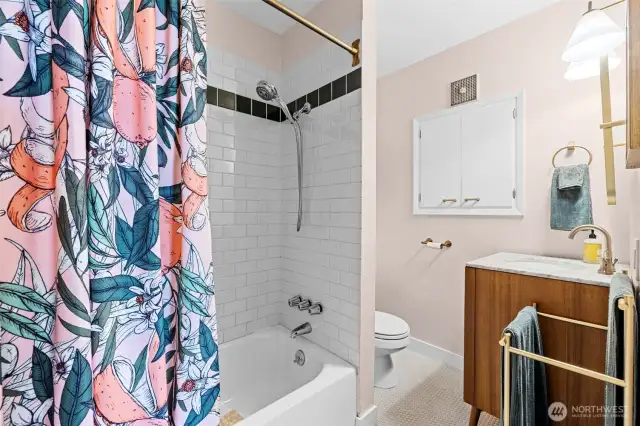 Subway tiled tub/shower, updated vanity and built in storage