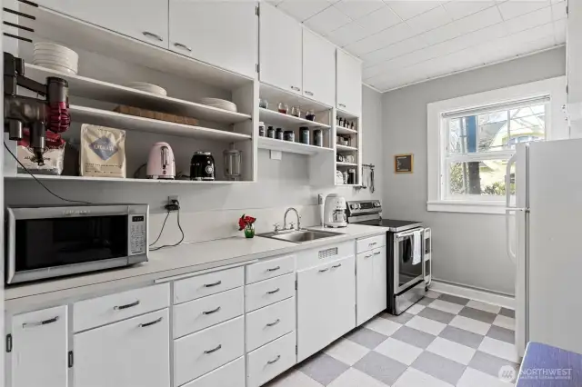 Lots of cabinets and open shelving for storage & new range