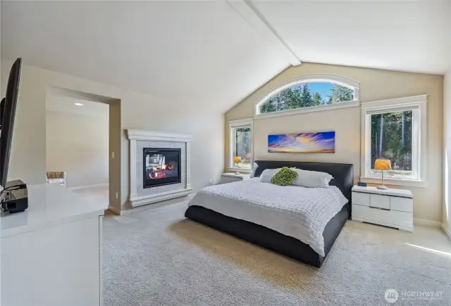 This room is light and spacious with a vaulted ceiling, a double-sided gas fireplace and view windows.