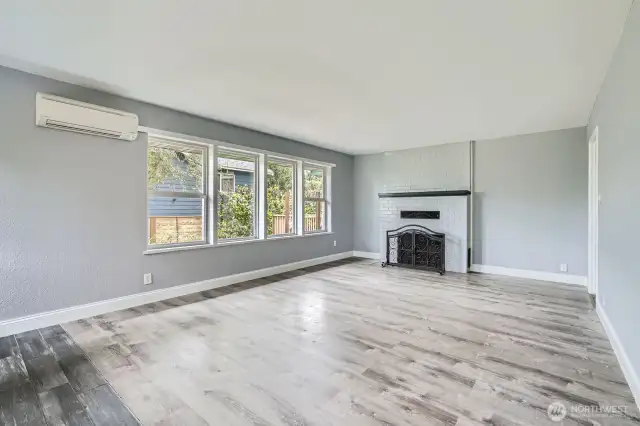 Spacious living room with A/C for warm days and a wood burning fireplace for cool nights.