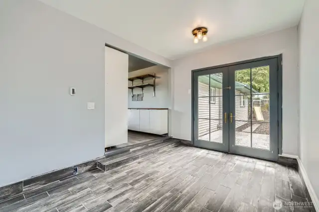 Dining area with French doors to patio and side yard.