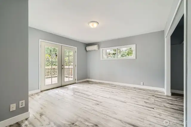 Primary Bedroom with French doors leading to private deck.