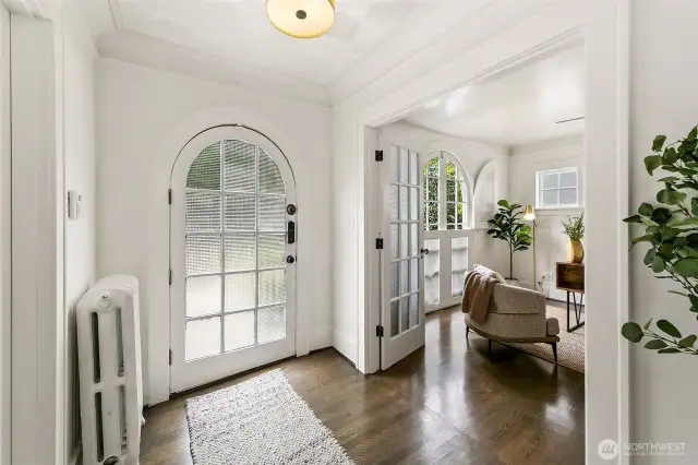 Arched primary door and windows ground the home in classically charming detail. Thick moulding and woodwork is gorgeous.