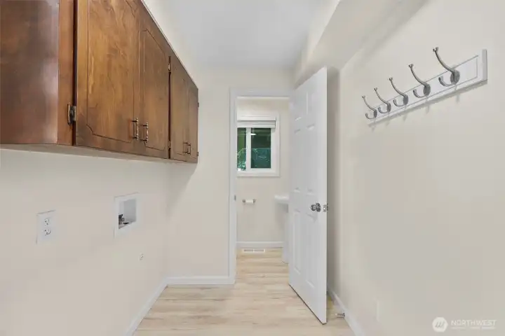 Laundry room with powder room in back of photo.