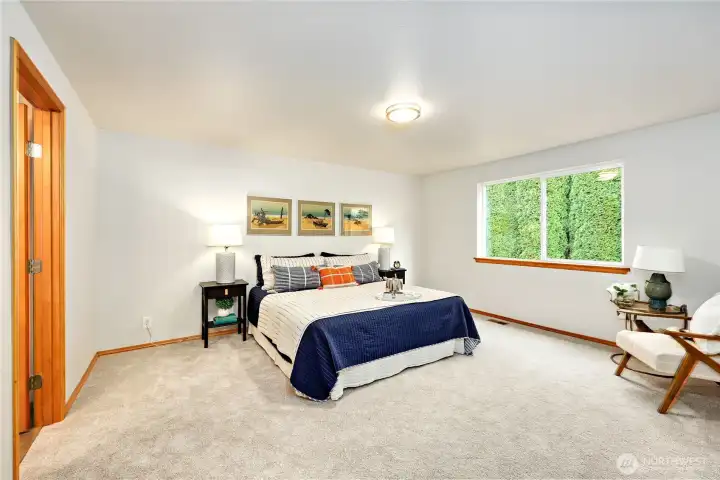 Comfortable Main floor Primary Suite can easily accommodate a King-sized bed.