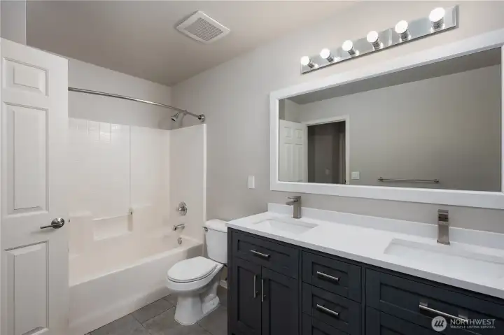 Full guest bathroom serving the 3 bedrooms and media room upstairs.
