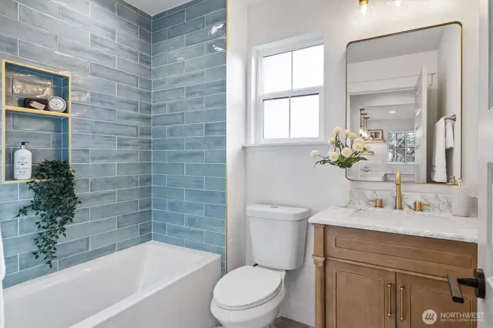 Main level hall bathroom with artisan tiled shower/tub combo