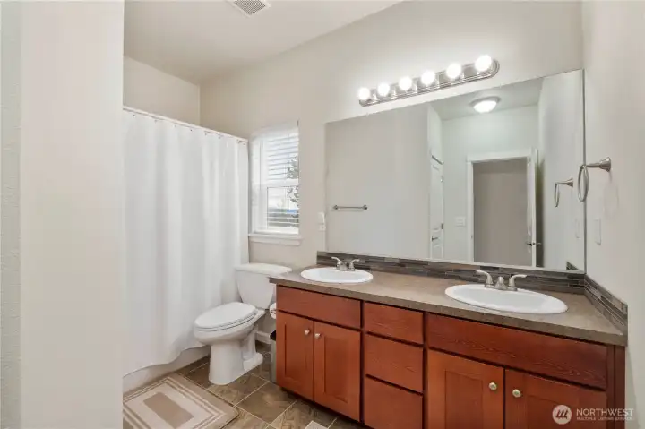 The hall bath is conveniently placed between the 2 additional bedrooms.