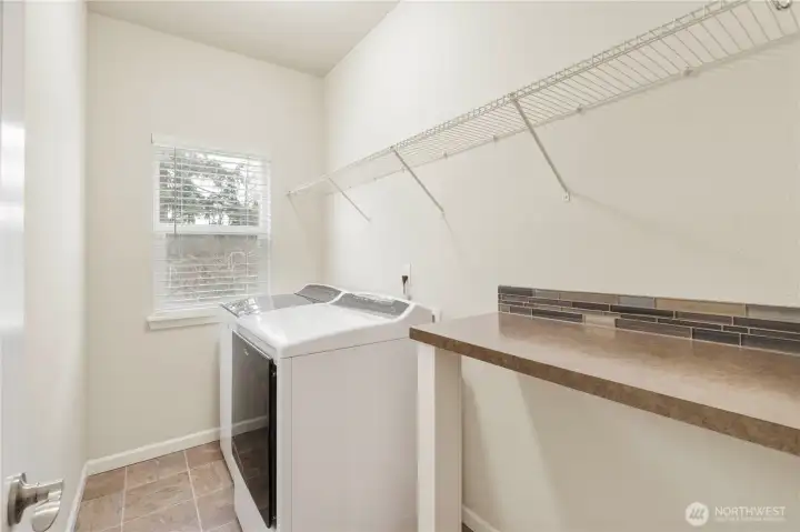 Large laundry room and folding counter.