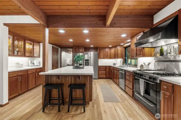 Light-filled and luxurious. The interplay between the neutral quartz and the honeyed tones of the wood creates a bright, inviting culinary hub.