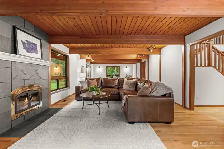 The heart of the home. This expansive living area offers the perfect balance of grand architectural volume and the cozy, intimate warmth of a flickering hearth.