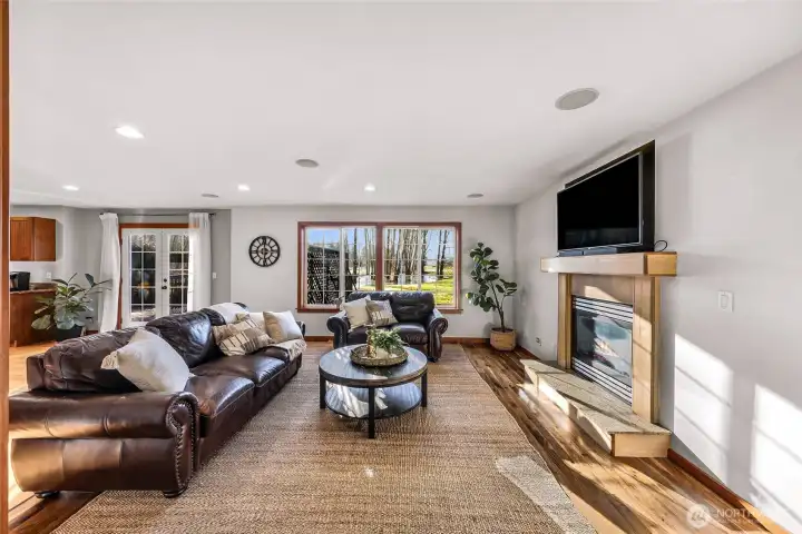 Living room offers a welcoming atmosphere  with generous natural light and room for  multiple furniture arrangements. The layout  supports both conversation and relaxation.