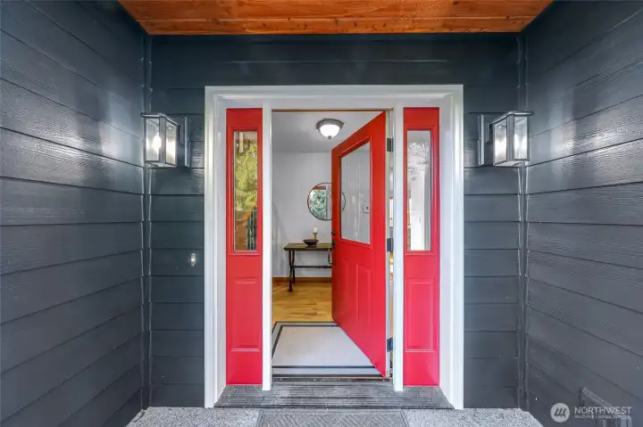 Covered entry with bold accent door creates  a welcoming arrival and weather-protected  access. Updated exterior paint enhances  curb appeal while maintaining timeless style.