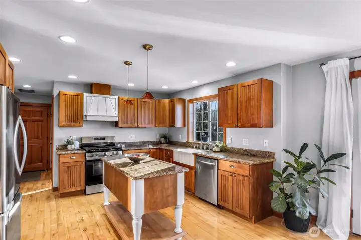Light-filled kitchen features a practical layout with abundant cabinetry, durable surfaces, and a newly installed range. Positioned for connection to dining and living areas, this space supports both daily routines and gatherings. Light-filled kitchen features a practical layout with abundant cabinetry, durable surfaces, and a newly installed range. Positioned for connection to dining and living areas, this space supports both daily routines and gatherings.