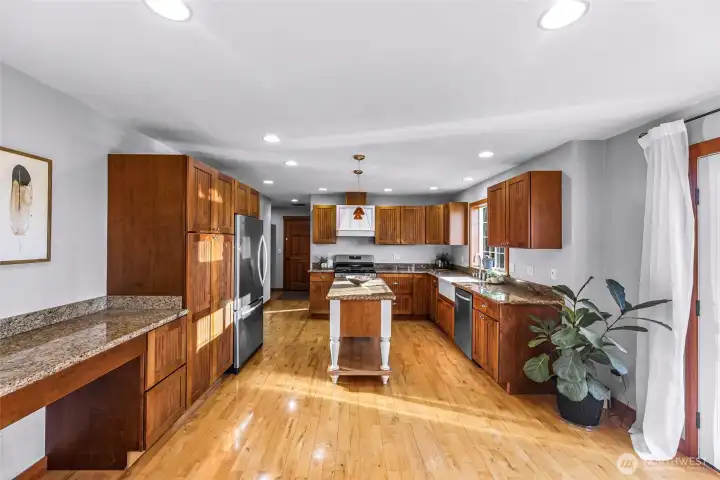 Extended kitchen view shows generous prep  space and durable finishes. A functional  environment designed for longevity and  ease.