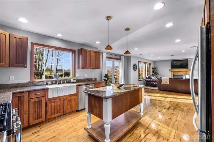 Wide kitchen perspective emphasizes  storage, workspace, and natural light.  Designed for efficiency without sacrificing  comfort.
