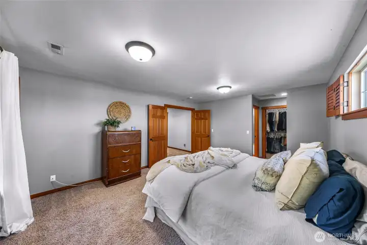 Upper-level bedroom offers comfortable  proportions and natural light. Ideal for  guests, family, or flexible use.