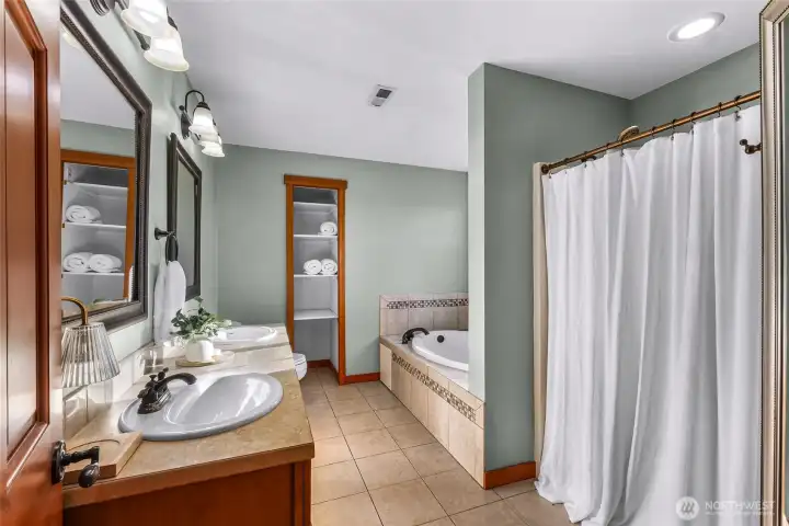 Full bathroom features practical layout and  durable finishes. Well-positioned to serve  adjacent bedrooms.