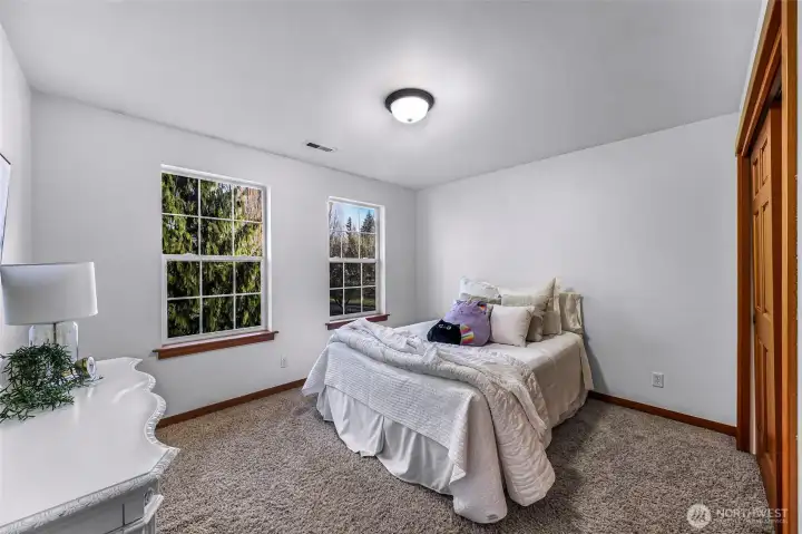 Additional bedroom with peaceful views and  ample space. Neutral palette allows for  versatile use.