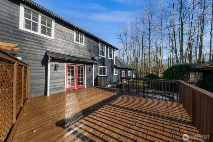 Expansive deck extends living outdoors,  offering space for entertaining, relaxing, or  enjoying the surrounding land. A natural  extension of the home.