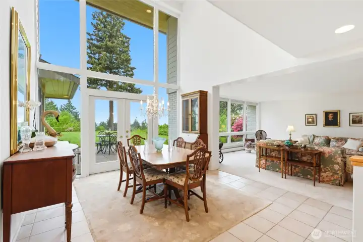 Formal dining room that get natural light through a wall of glass and vaulted ceiling.