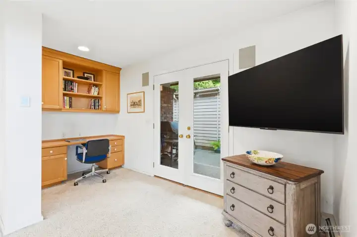 A small desk area is located to the left of the family room and the door leads out to the pool.