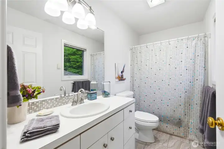 One of the upper level full bathrooms serves two bedrooms.