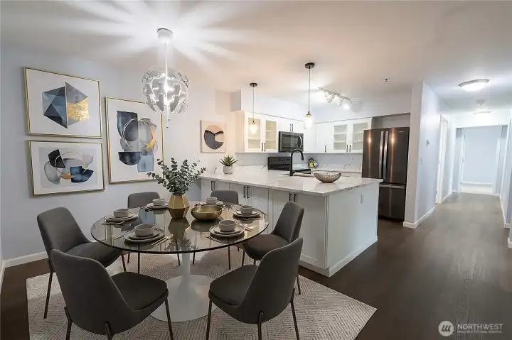 Beautifully updated kitchen with Quartz counter tops, oversized island, stainless steel appliances and abundant storage. Photo is virtually-staged
