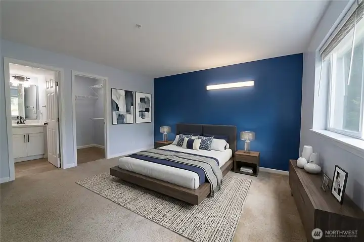 Generously sized primary suite with room for a sitting area, large windows, and a calming retreat-like atmosphere